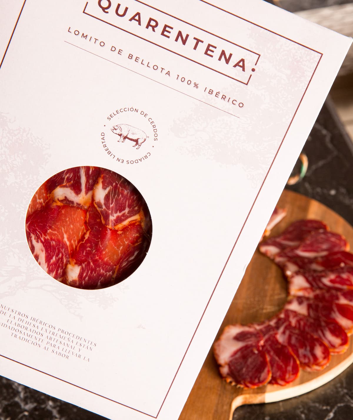 Quarentena cured meat packaging with sliced meat on a wooden board